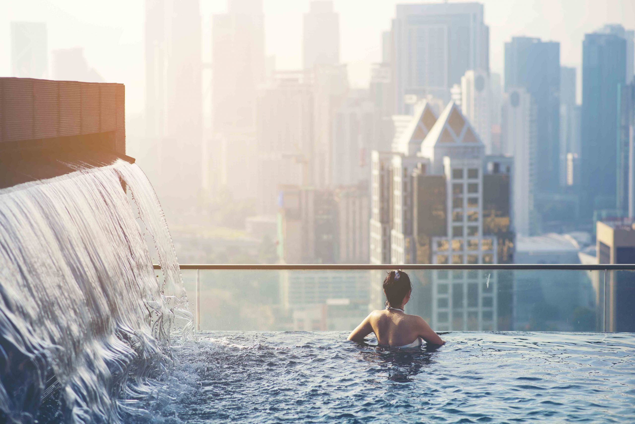 Woman at pool looking to horizon